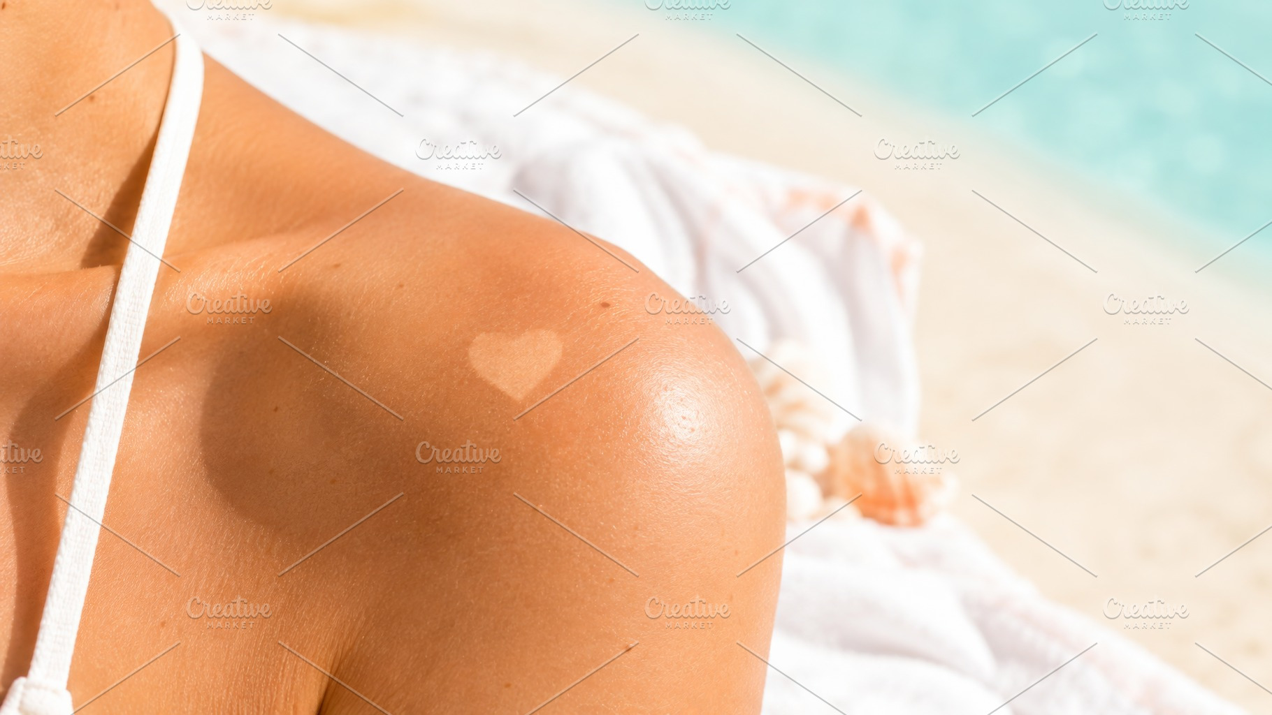 Heart-shaped suntan tattoo on should, a Photo by Dvoevnore photos
