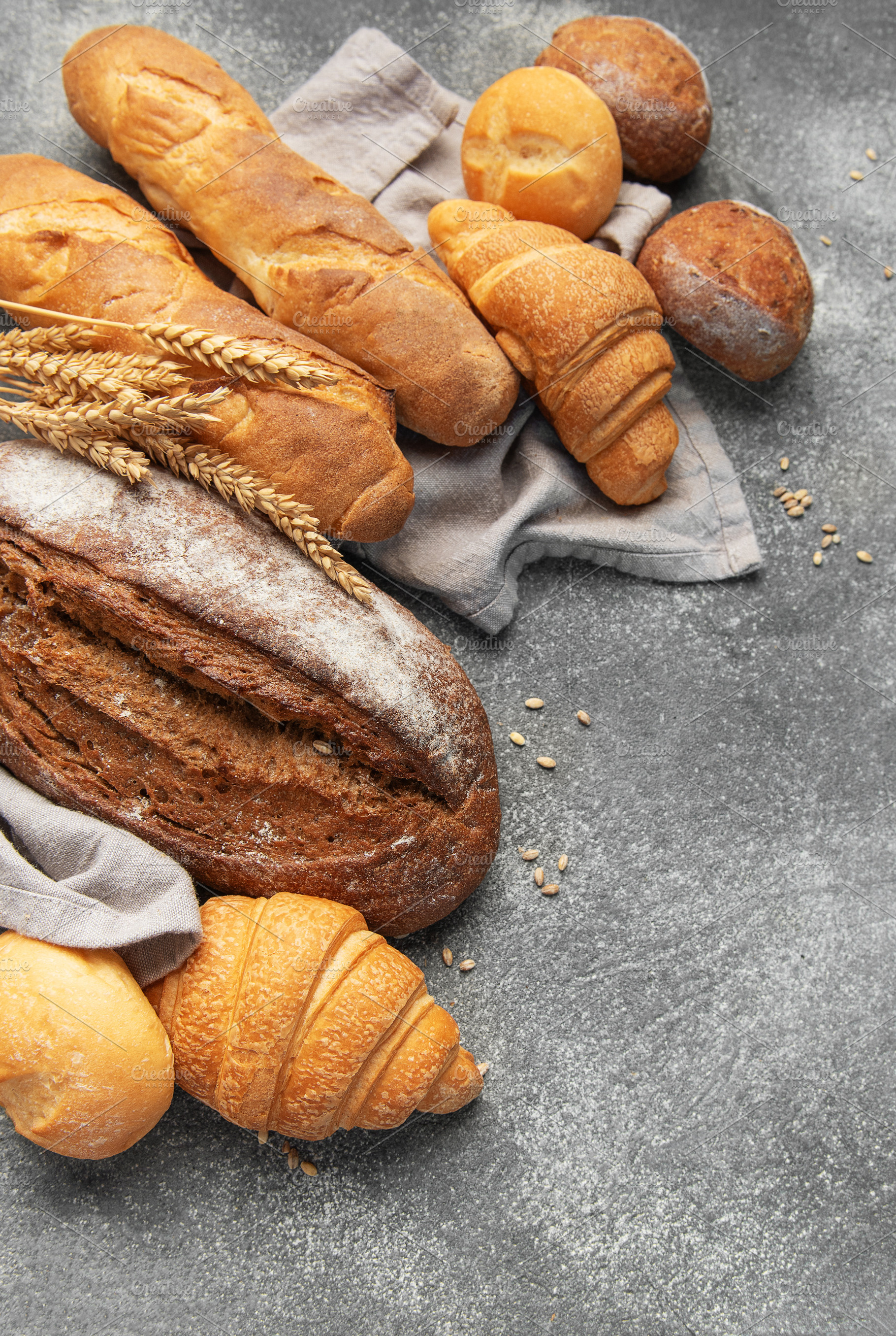 Fresh baked bread, baguettes, croissants, and buns assortment, a Food & Drink Photo by Olena Rudo