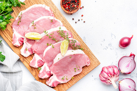 Raw pork chops, loin  on wooden cutting board prepared for cooki, a Food & Drink Photo by 5PH