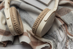 Warm plaid, headphones, book, and eyeglasses creating cozy atmos, a Business Photo by Olena Rudo