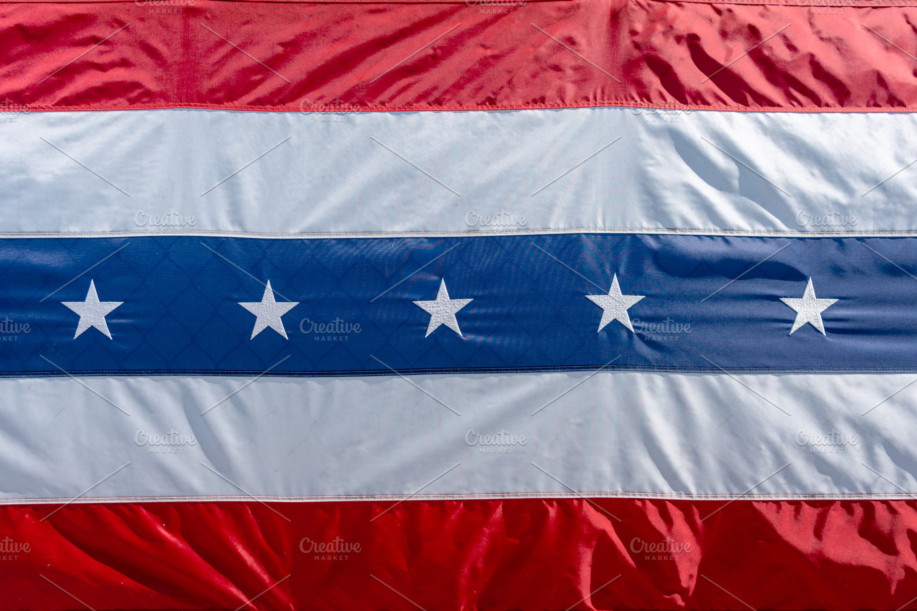 Close-up of a red, white, and blue patriotic flag with stars. US, a Photo by GoodGoods