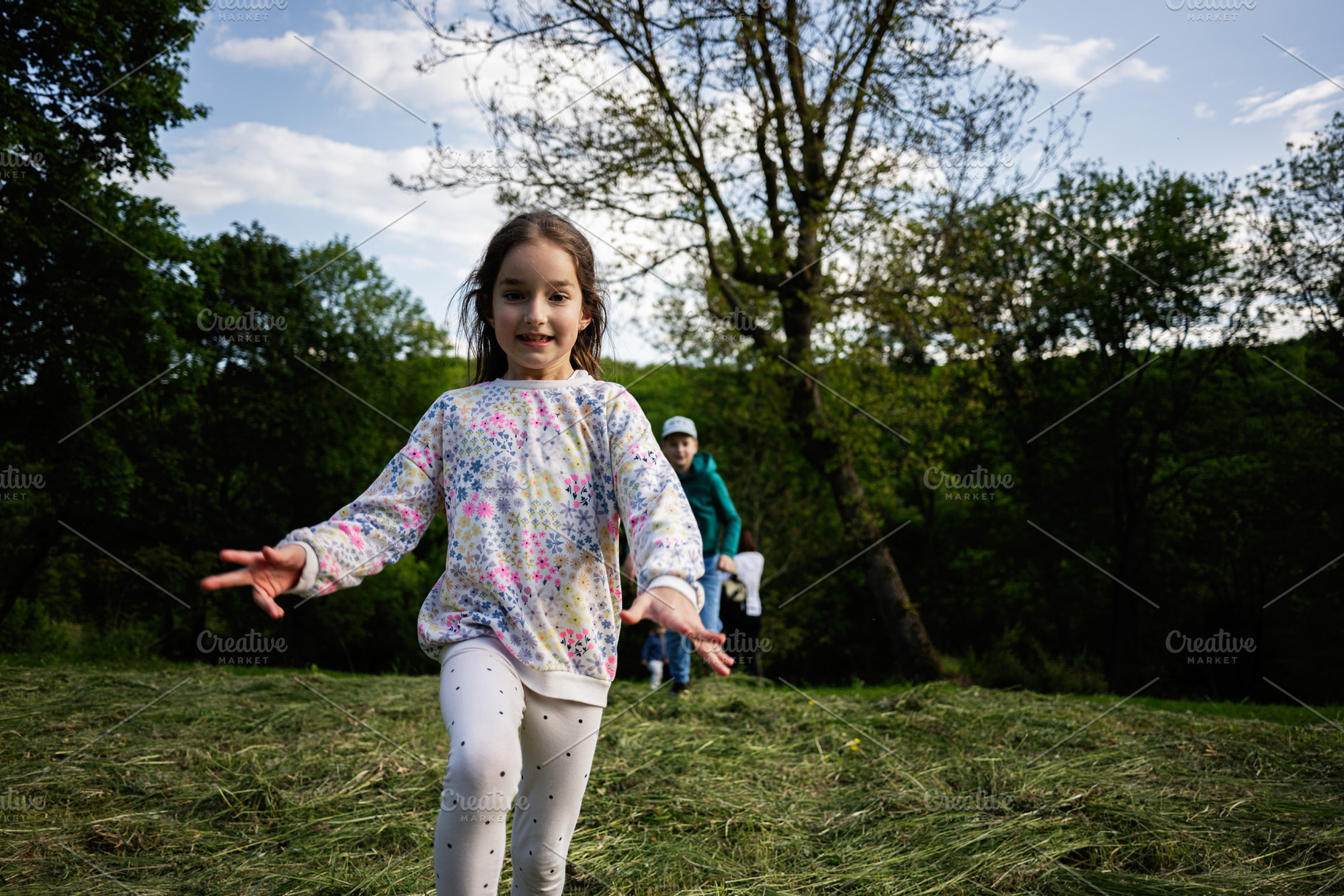 Young girl joyfully running in the park on a sunny day, a Person Photo by AS photostudio