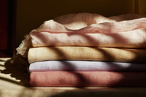 Stacks of folded linen cloth resting, a Photo by Pavel_design