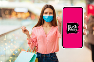 Lady Showing Phone Advertising Black Friday Shopping Offer In Mall, a Photo by Prostock-Studio