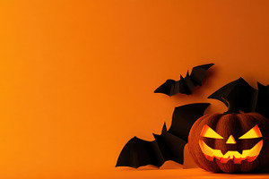 Glowing jack o lantern with black bats on orange Halloween backg, a Person Photo by José Manuel Gelpi
