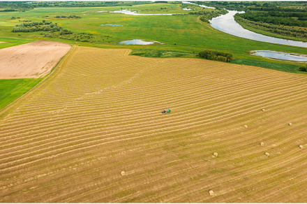 Aerial View Tractor Collects Dry, an Industrial Photo by Our Amazing World