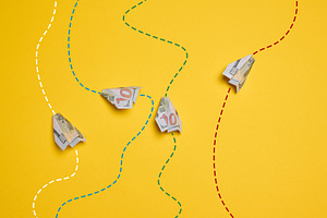 Four paper airplanes made from hundred-dollar bills, with dotted, a Business Photo by ndanko
