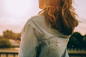 Girl in the rays of the setting sun