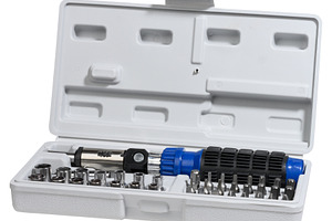 Set of tools in a white plastic case. Inside is a universal scre, a Technology Photo by ndanko