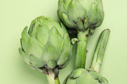 Concept of healthy food with artichoke on green background, a Food & Drink Photo by AtlasStudio PRO