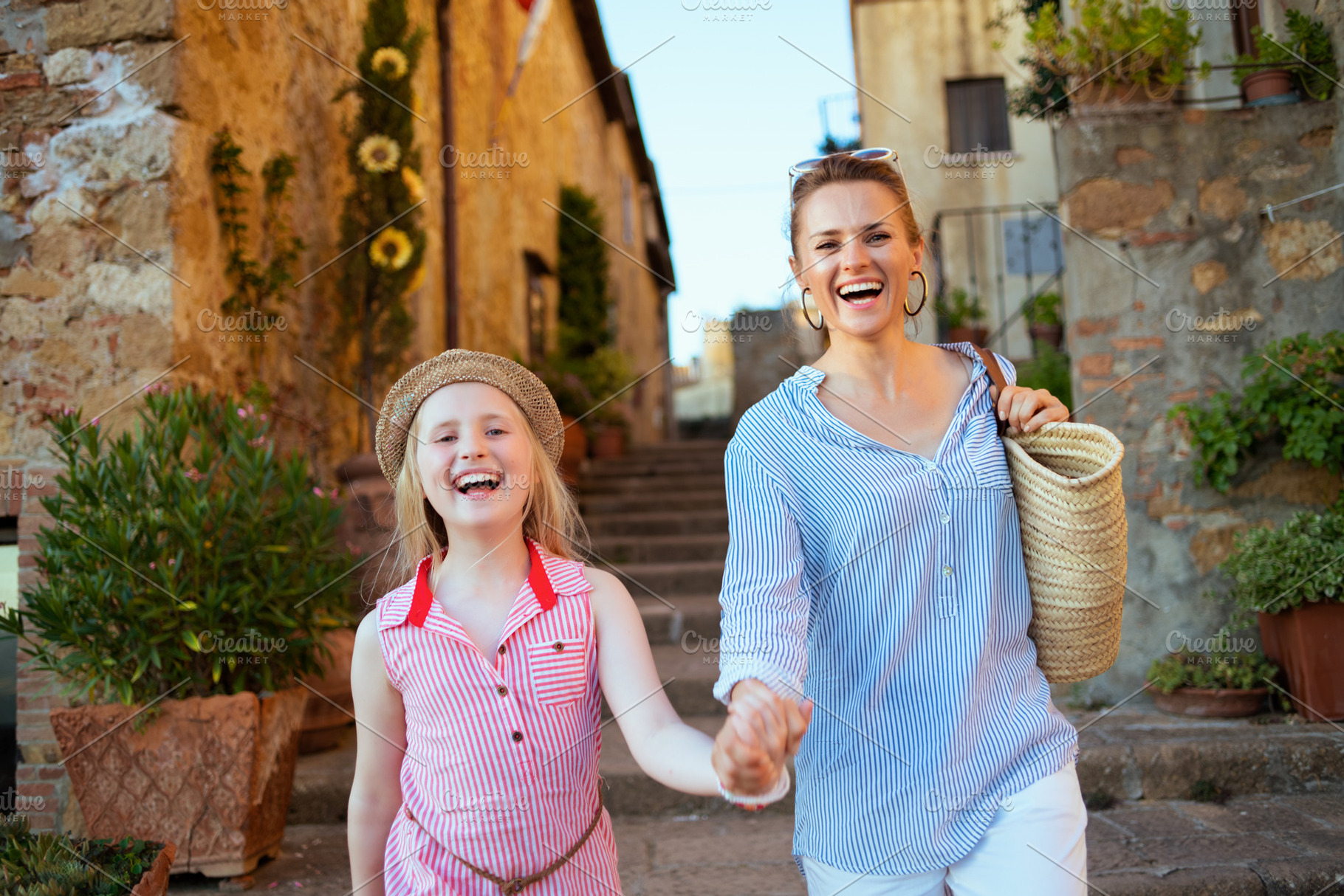 smiling stylish mom and child travellers exploring attractions, a Person Photo by Alliance Images