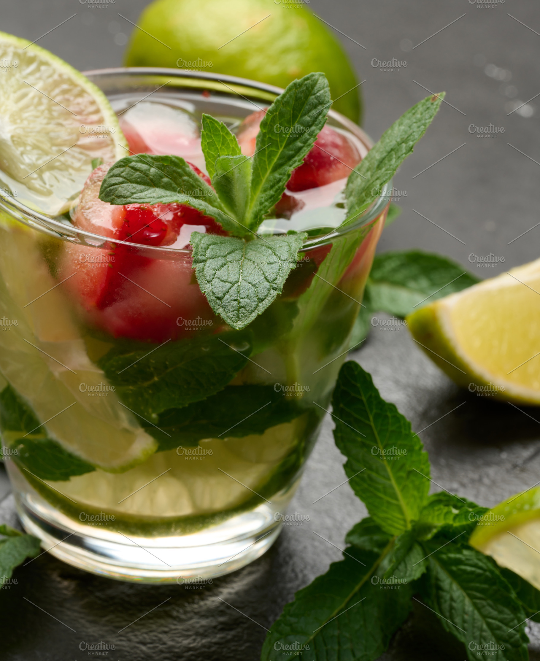 Refreshing mojito cocktail with lime, mint, strawberry, and ice, a Food & Drink Photo by ndanko