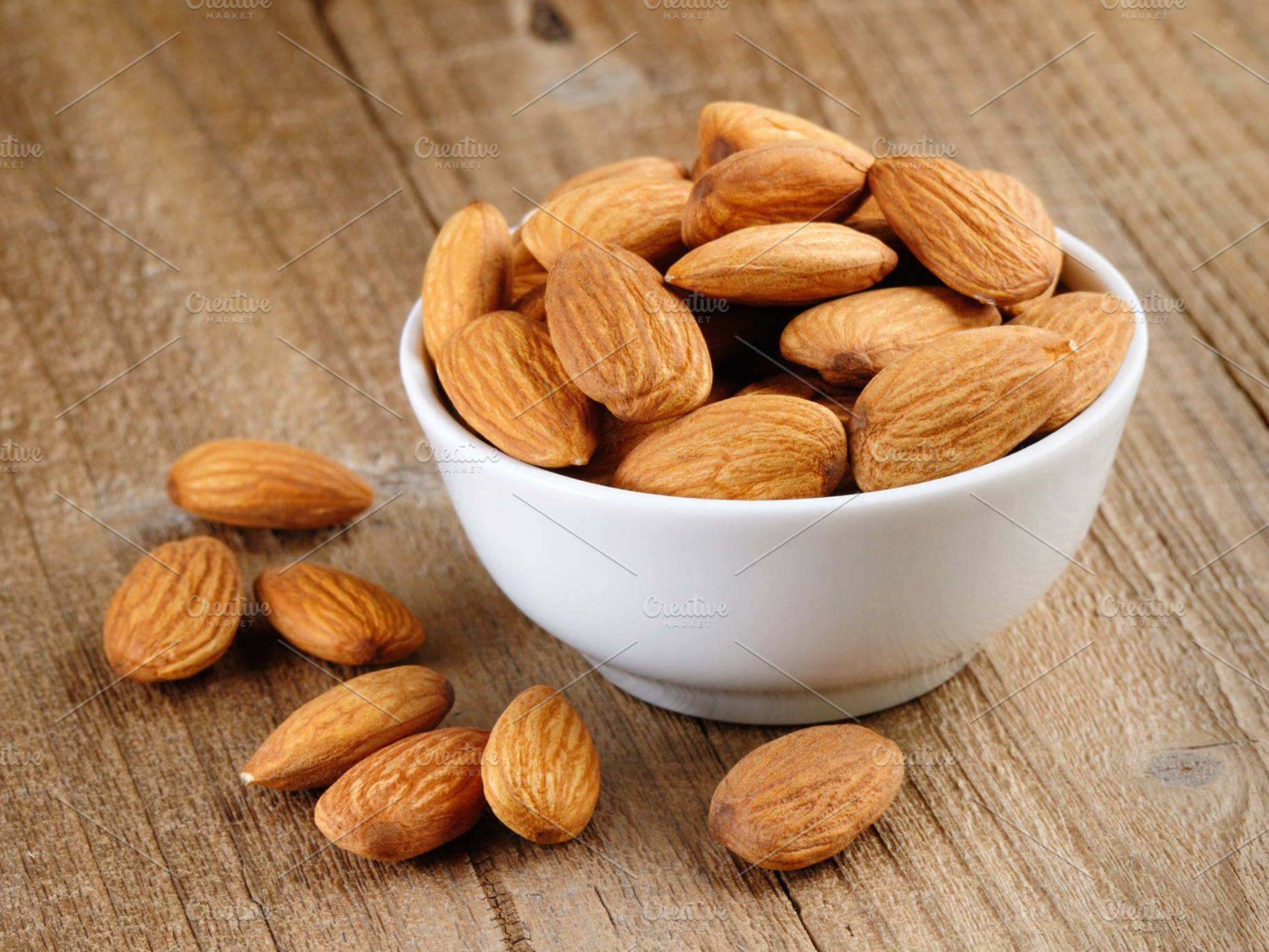 Almonds in bowl containing almonds, brown, and food