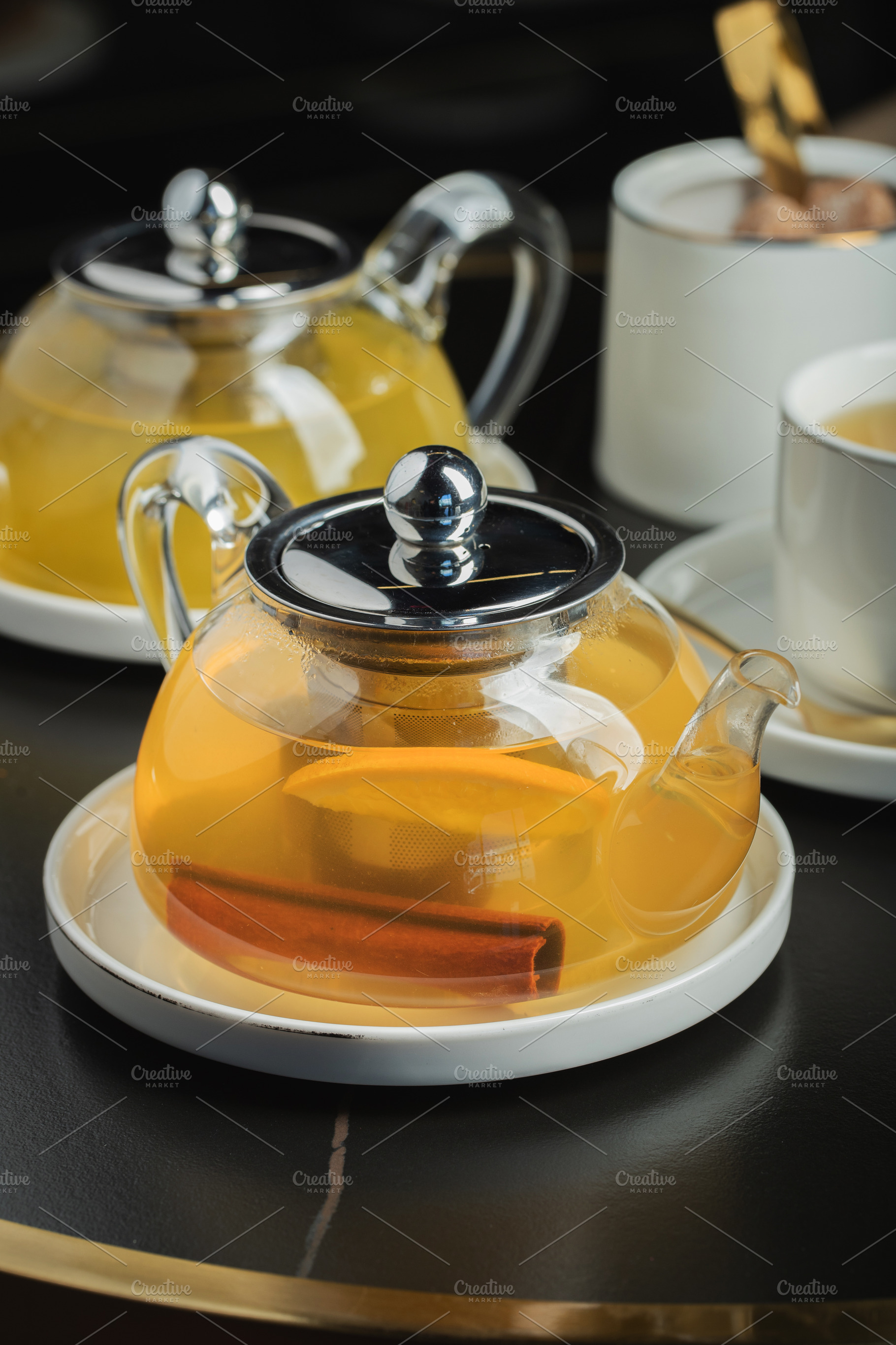 Fruit tea with mango and mint in a glass teapot on the table, a Food & Drink Photo by Budarinphoto