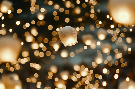 Yi Peng lanterns floating in night sky during Loi Krathong festi
