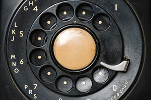 Close up of old rotary dial on telephone, a Technology Photo by Backyard Stock