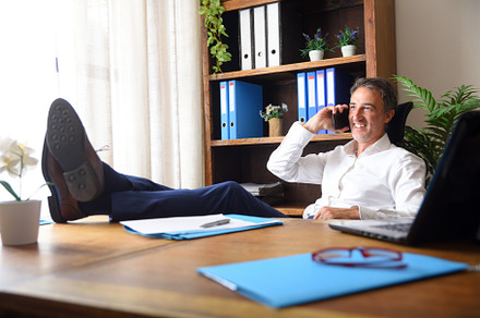 Businessman talking with mobile with feet on table in office, a Business Photo by Davizro's Market