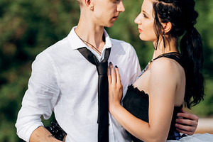 A couple of newlywed freaks on a black custom bike, a Person Photo by Weddings, People, Travel