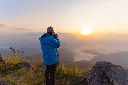 Portrait of Asian man, a photographer tourist holding a camera,, a Person Photo by Tampatra