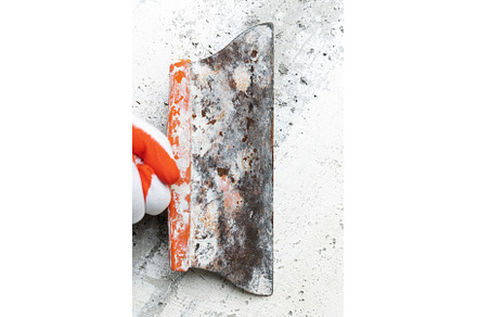 Plasterer using spatula and scrapes, an Industrial Photo by Alexander-Piragis