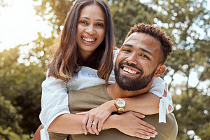 Love, black couple and with smile hug, bonding and happy together outdoor for fun, loving and embrace. Portrait, romance and man with woman with happiness, for marriage, relationship and celebrate., a Photo by Peopleimages.com