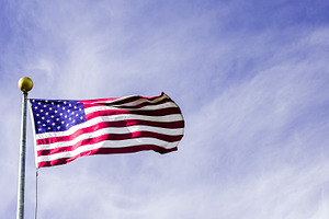 Waving American flag against a clear, a Holiday Photo by 1miromiro