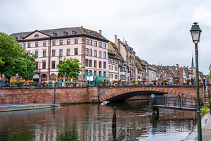 Bridge with flowers over the Ill river in Strasbourg, France, an Architecture Photo by GoodGoods