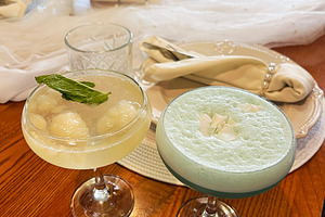 Elegant table setting with crafted cocktails and intricate dinnerware, a Photo by AS photostudio