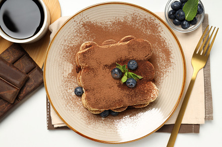 Concept of sweet food, Tiramisu cake, top view, a Food & Drink Photo by AtlasStudio PRO