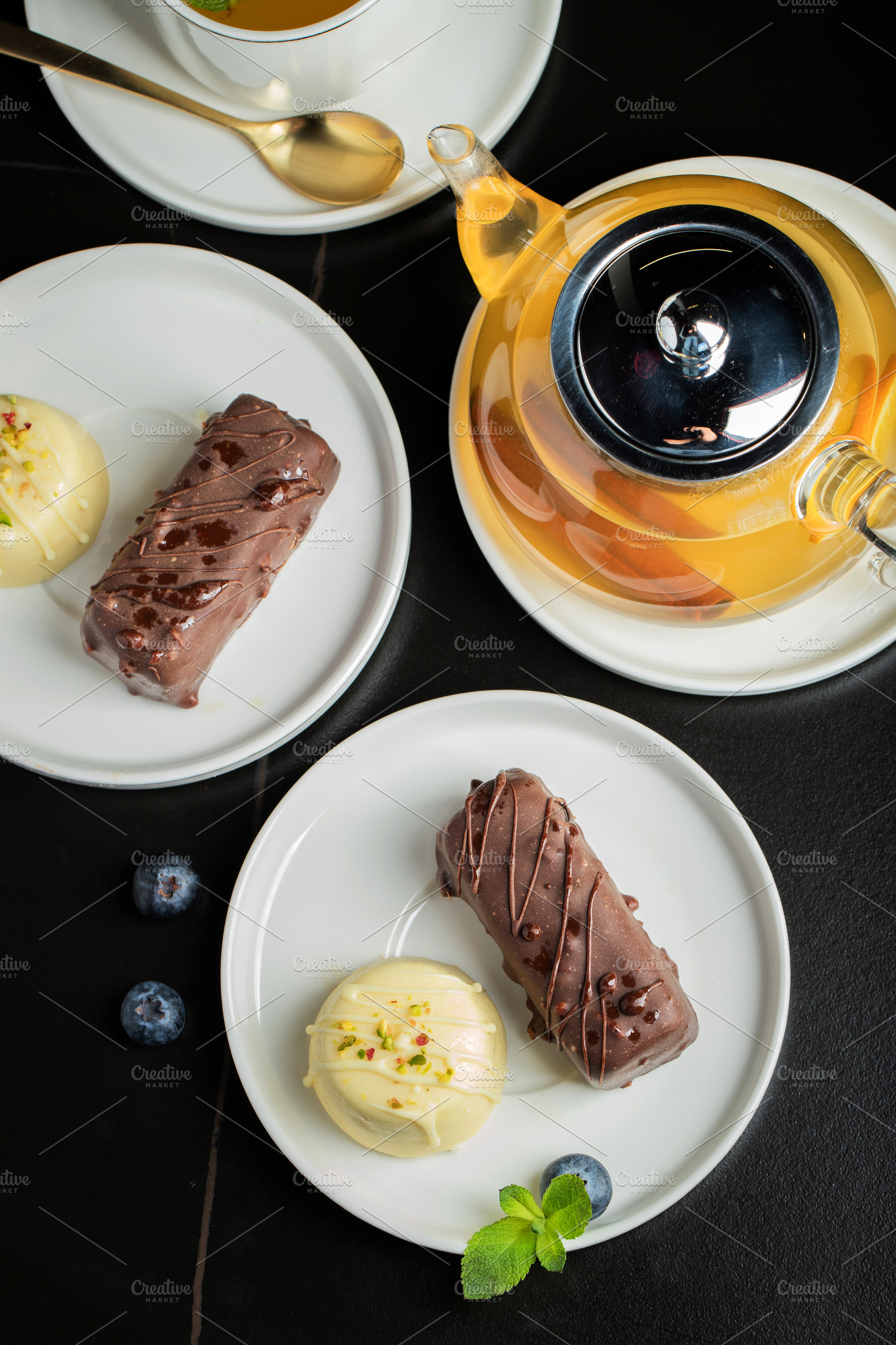 Delicious glazed curd snacks with fresh blueberries and mint on light grey tabl, a Food & Drink Photo by Budarinphoto