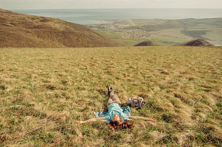 Happy hiker woman lying