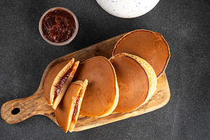 Dorayaki, classic Japanese pastry with sweet red bean paste or s, a Food & Drink Photo by Rimma