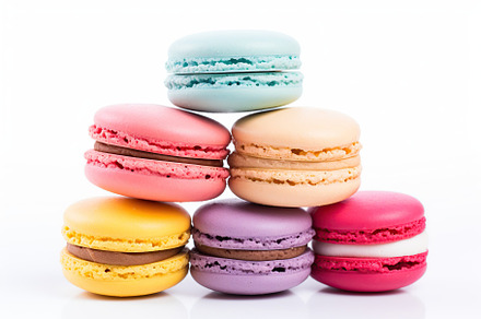 Colorful macarons dessert on white background, a Food & Drink Photo by AlyaAnd