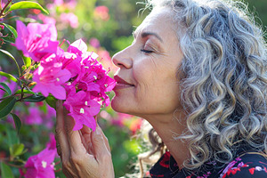 Profile of a woman smelling pink flowers, a Person Photo by DanFLCreativo