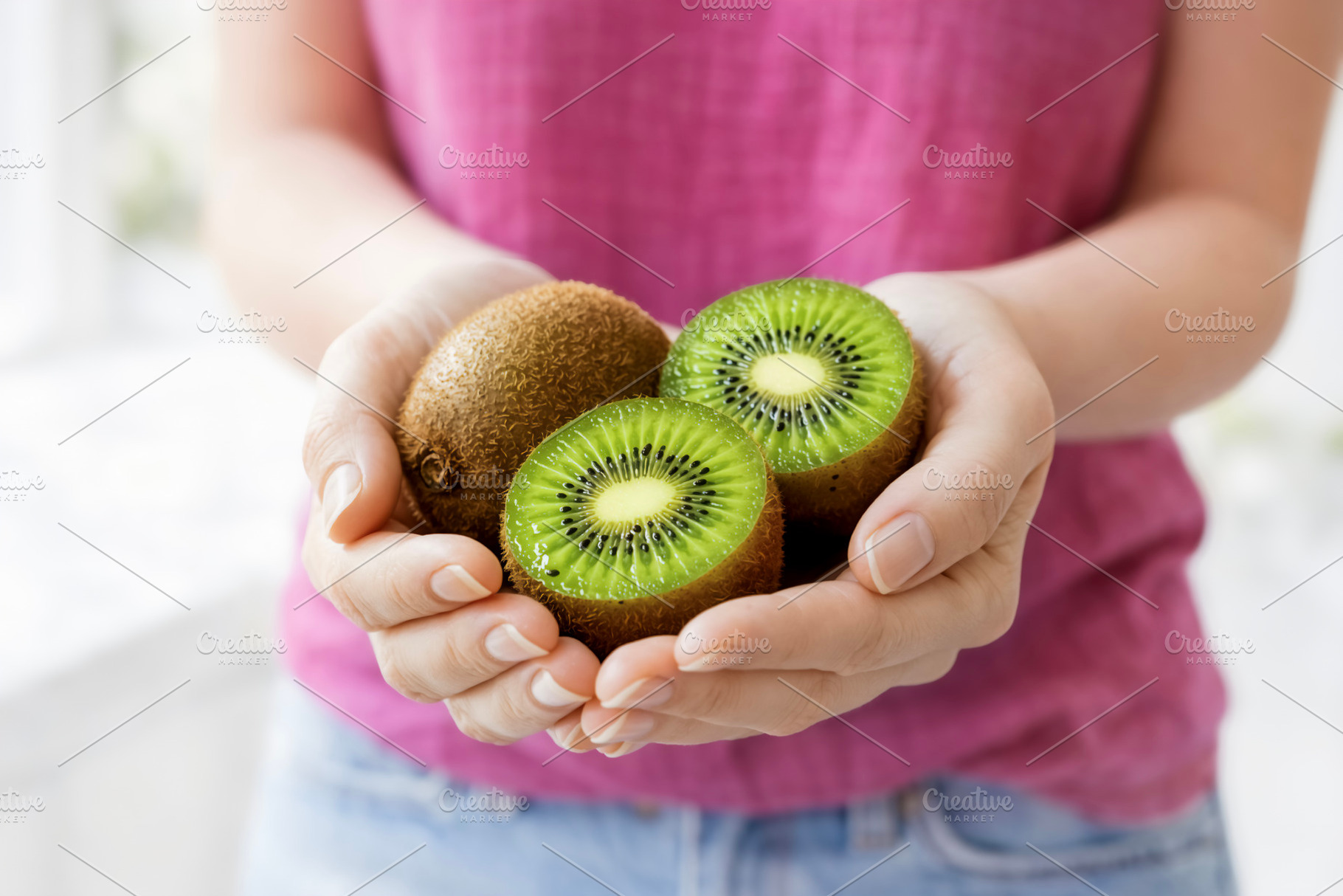 Woman Holding Fresh Kiwi, a Photo by rarrarorro