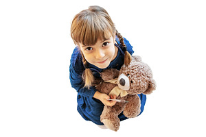 child treats a bear. The game of the, a Health & Medical Photo by yanadjana
