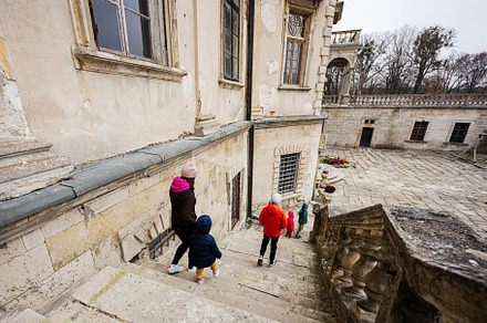 Mother with four kids walking on stairs, visit Pidhirtsi Castle,, a Person Photo by AS photostudio