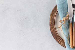 Rustic Table Setting with Blue Linen and Wooden Cutlery on Light, a Food & Drink Photo by Natalia Klenova's Shop