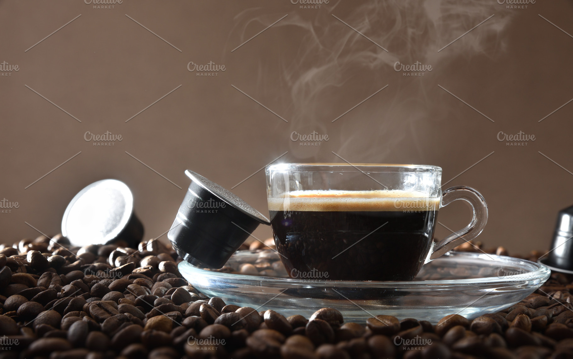 Espresso cup on ground coffee with capsules around front view, a Food & Drink Photo by Davizro's Market