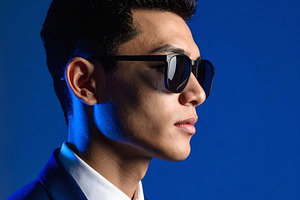 Businessman in elegant suit wearing sunglasses with blue light, a Business Photo by GoodGoods
