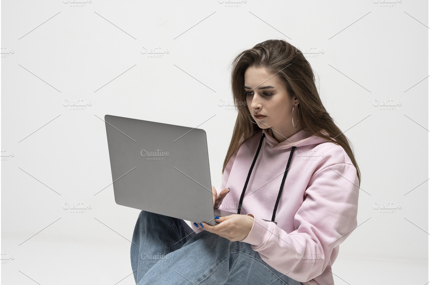 Young woman sitting on floor in pink, a Person Photo by volodymyrshtun13795