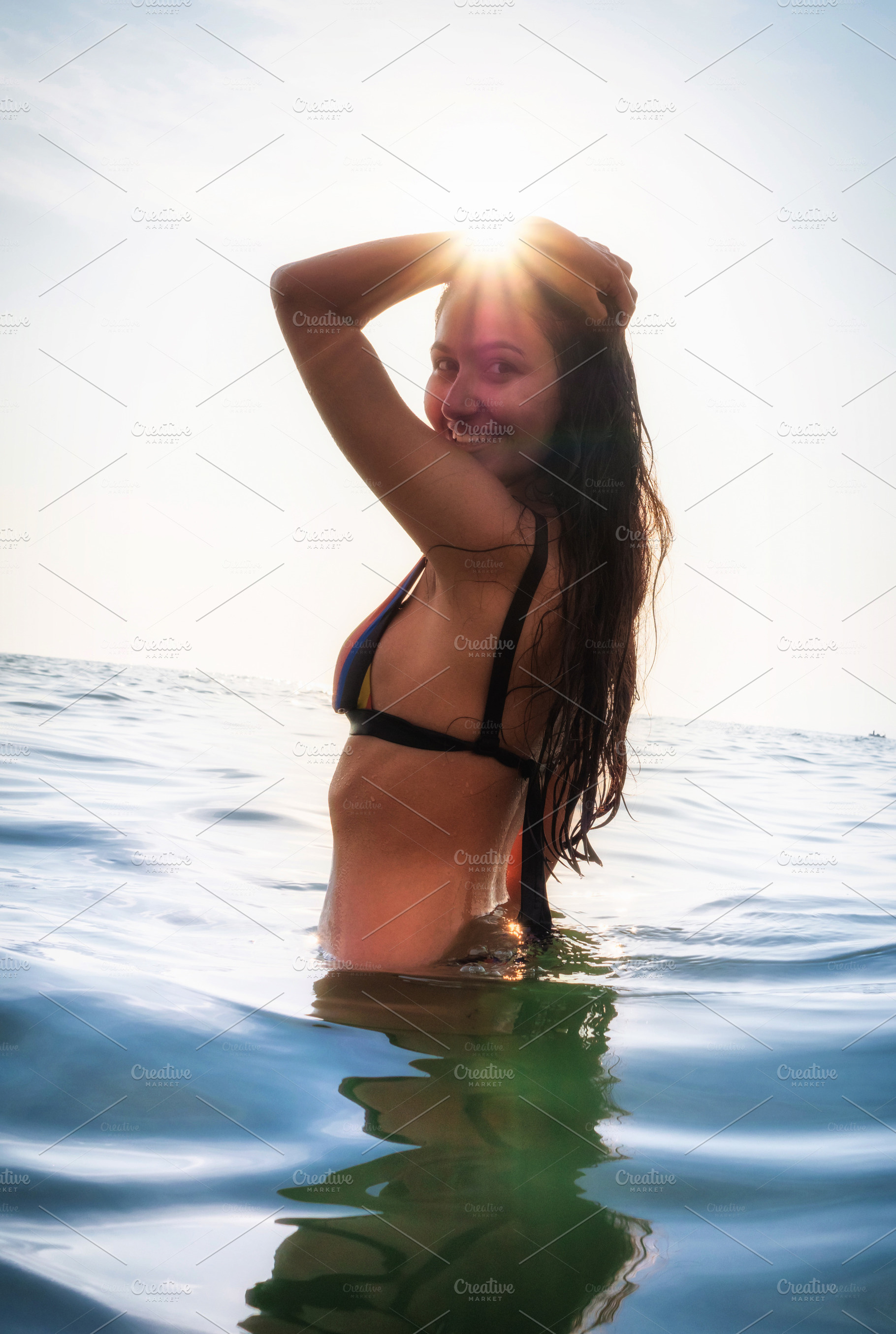 Young woman in bikini takes a bath in the sea at sunset lights i, a Person Photo by Antonio Gravante Market