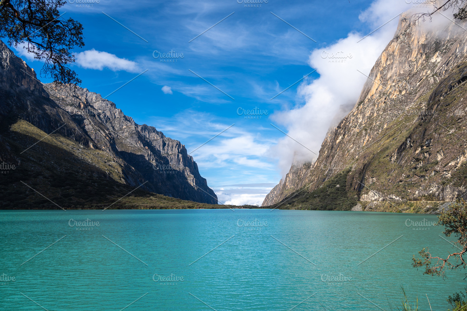 Turquoise lake surrounded by mountains on the Laguna 69 trek, Pe, a Photo by GoodGoods