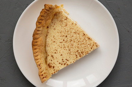 Homemade Sugar Cream Pie on a white plate on a gray background,, a Food & Drink Photo by LiudmylaChuhunova