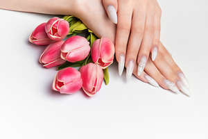 Elegant woman hands with long white manicure nails, a Photo by Olena Rudo