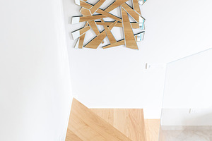 Modern wooden staircase with abstract mirror on white wall, an Architecture Photo by Antonio Gravante Market