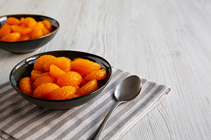 Organic Canned Mandarin Oranges in Bowls, side view. Copy space., a Food & Drink Photo by LiudmylaChuhunova