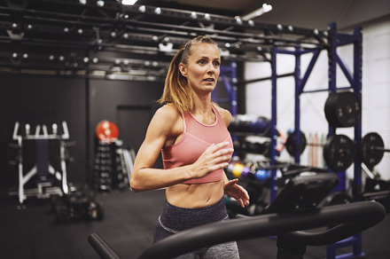 Mature woman focused on her treadmill run at the gym, a Sports & Recreation Photo by Stefan & Janni
