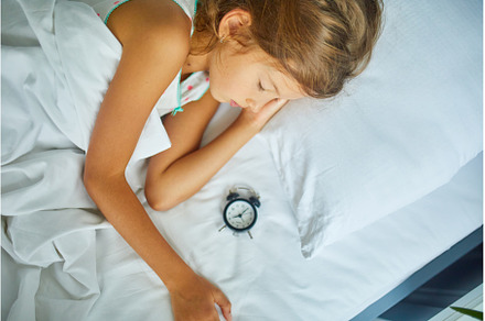Little girl sleeping on a big and, a Person Photo by IlliaBondarPhotography