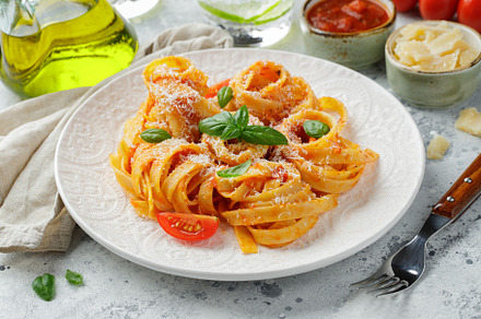 Tasty appetizing classic italian tagliatelle pasta with tomato sauce, cheese pa, a Food & Drink Photo by Budarinphoto